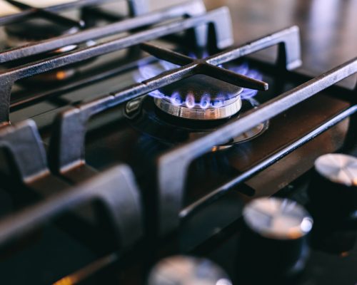 Gas flames burning on kitchen stove top